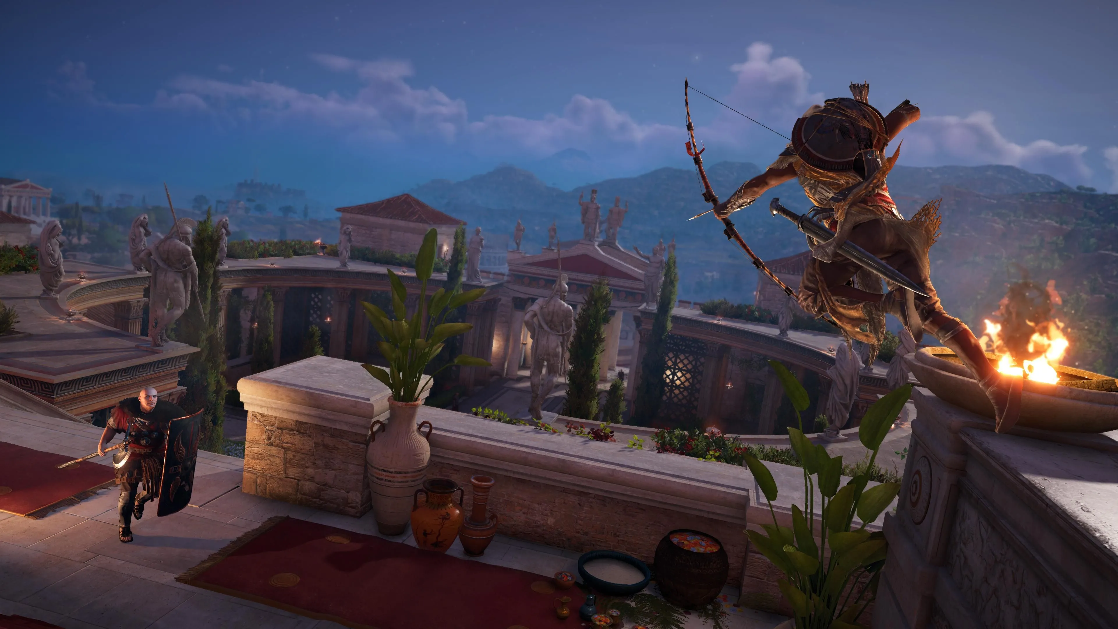 Bayek nhảy từ vách đá và nhắm cung vào người lính cầm khiên trong Assassin's Creed Origins