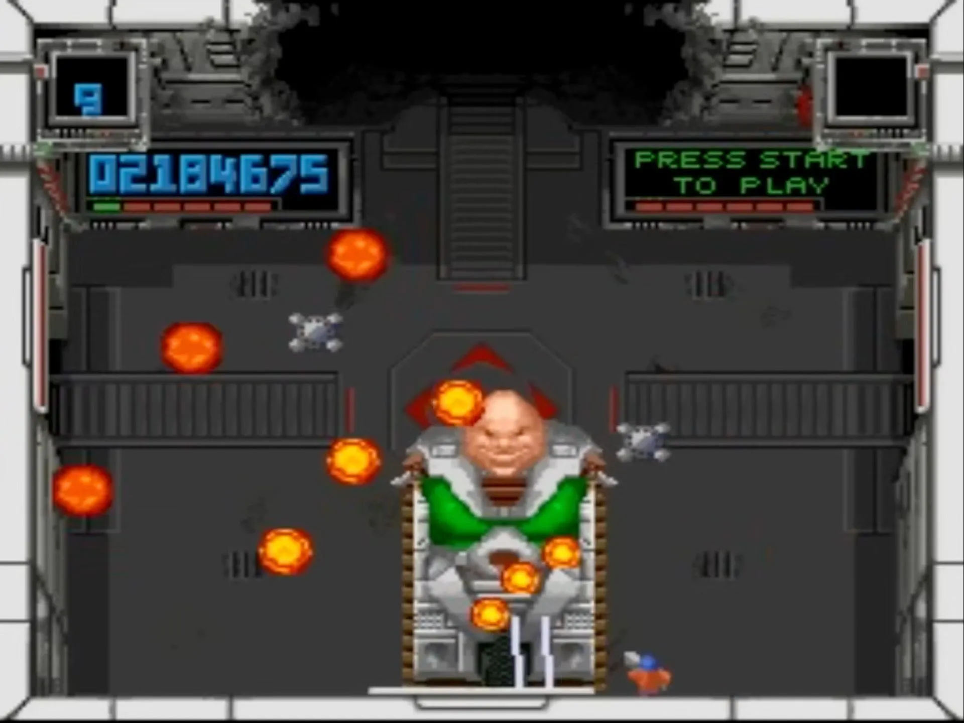 Cảnh game bắn súng góc nhìn từ trên xuống Super Smash TV trên SNES, với nhân vật chính đang chiến đấu trong một đấu trường đầy kẻ thù và vật phẩm.