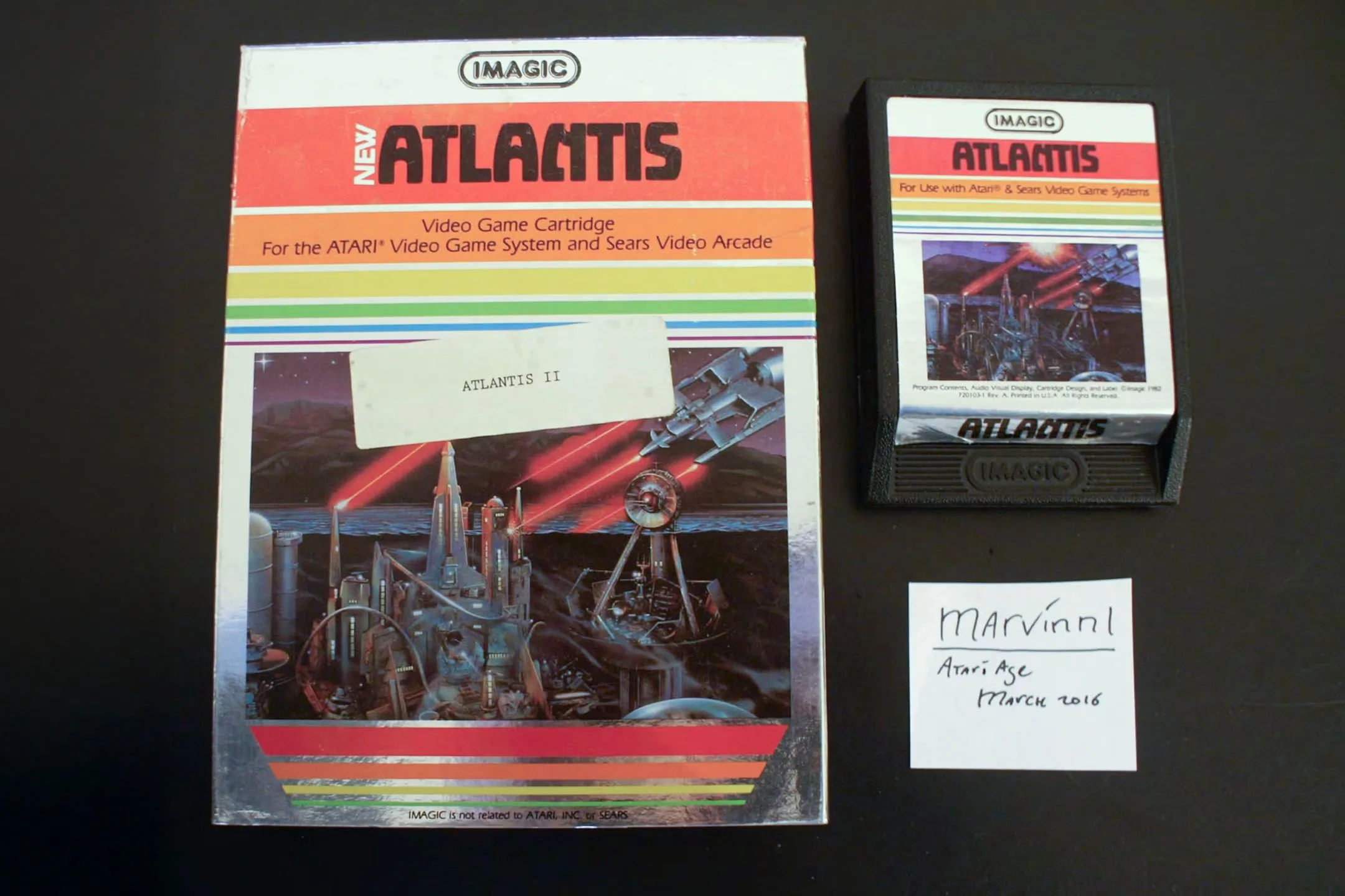 Hộp cartridge game Atlantis II hiếm cho hệ máy Atari 2600 với nhãn dán "Atlantis II" nhỏ, minh họa sự khó khăn trong việc phân biệt với bản gốc.